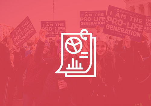 IPA_Research_Icon_Cover A crowd of people holding signs. Some say, "I AM THE POST-ROE GENERATION" and others say, "I AM THE PRO-LIFE GENERATION."